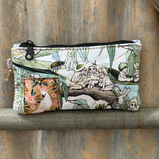 A rectangular zippered pouch with a whimsical woodland animal print, 